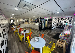Cow-print dining room with yellow chairs